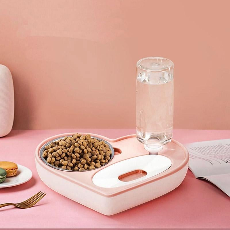 Furvana 2-in-1 heart-shaped pet feeder with a stainless steel food bowl and automatic water dispenser in soft pink.