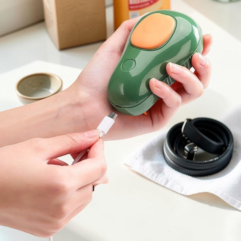 Furvana avocado-shaped pet grooming spray brush being charged with a USB cable, featuring green and orange plastic.