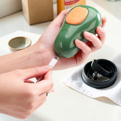 Furvana avocado-shaped pet grooming spray brush being charged with a USB cable, featuring green and orange plastic.