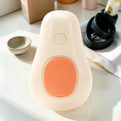 Furvana avocado-shaped pet grooming spray brush with a cream body and orange button for cats and dogs