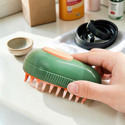 Furvana avocado-shaped pet grooming brush with green casing, orange silicone bristles, and a mist spray function.