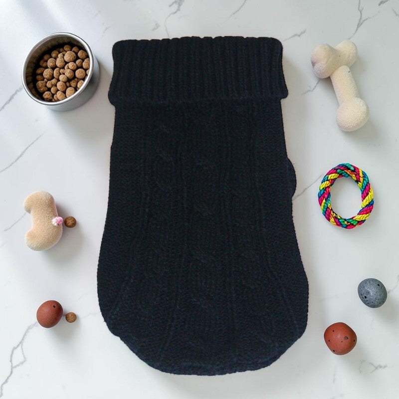 Furvana black knit pet sweater with a turtleneck design, laid flat on a white surface with dog toys and food bowl.