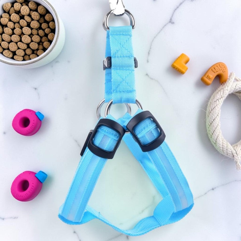 Furvana light blue LED nylon dog harness for nighttime safety with adjustable buckles on a marble surface.