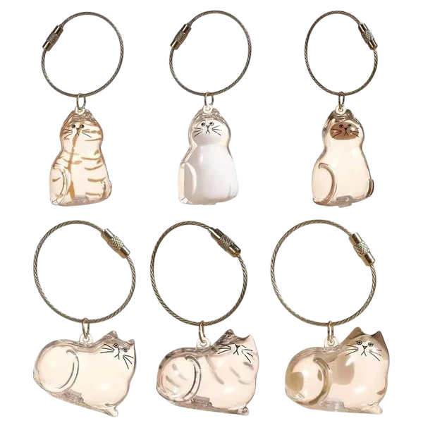 Furvana cat hair keepsake keychains in various clear twisted egg shapes with metal rings for keys or bags