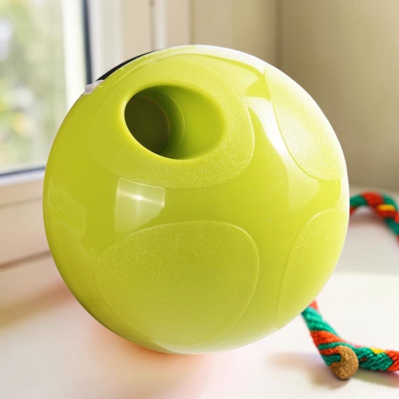 Furvana interactive green treat dispensing ball toy for pets made of durable ABS plastic