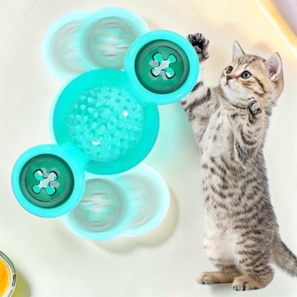 Furvana green windmill cat toy with spinning interactive bins and a textured center for dental care, played with by a kitten.