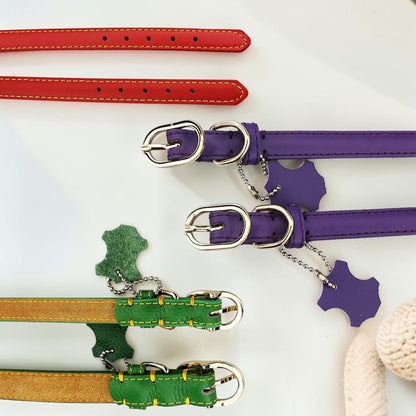 Furvana genuine cowhide leather dog collars in red, purple, and green with stainless steel buckles and hangtags.