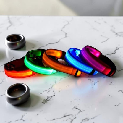 Furvana rechargeable LED safety dog collars in various bright neon colors arranged on a white surface