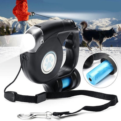 Furvana black retractable dog leash with built-in LED flashlight, ergonomic handle, and waste bag dispenser