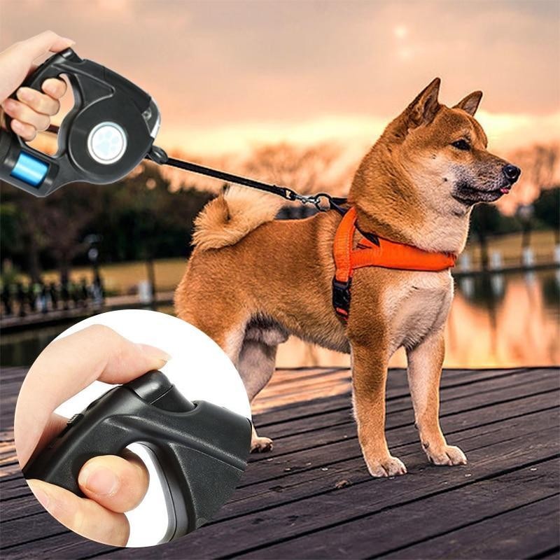 Furvana black LED retractable dog leash with ergonomic handle and thumb brake control being used on a dog walk
