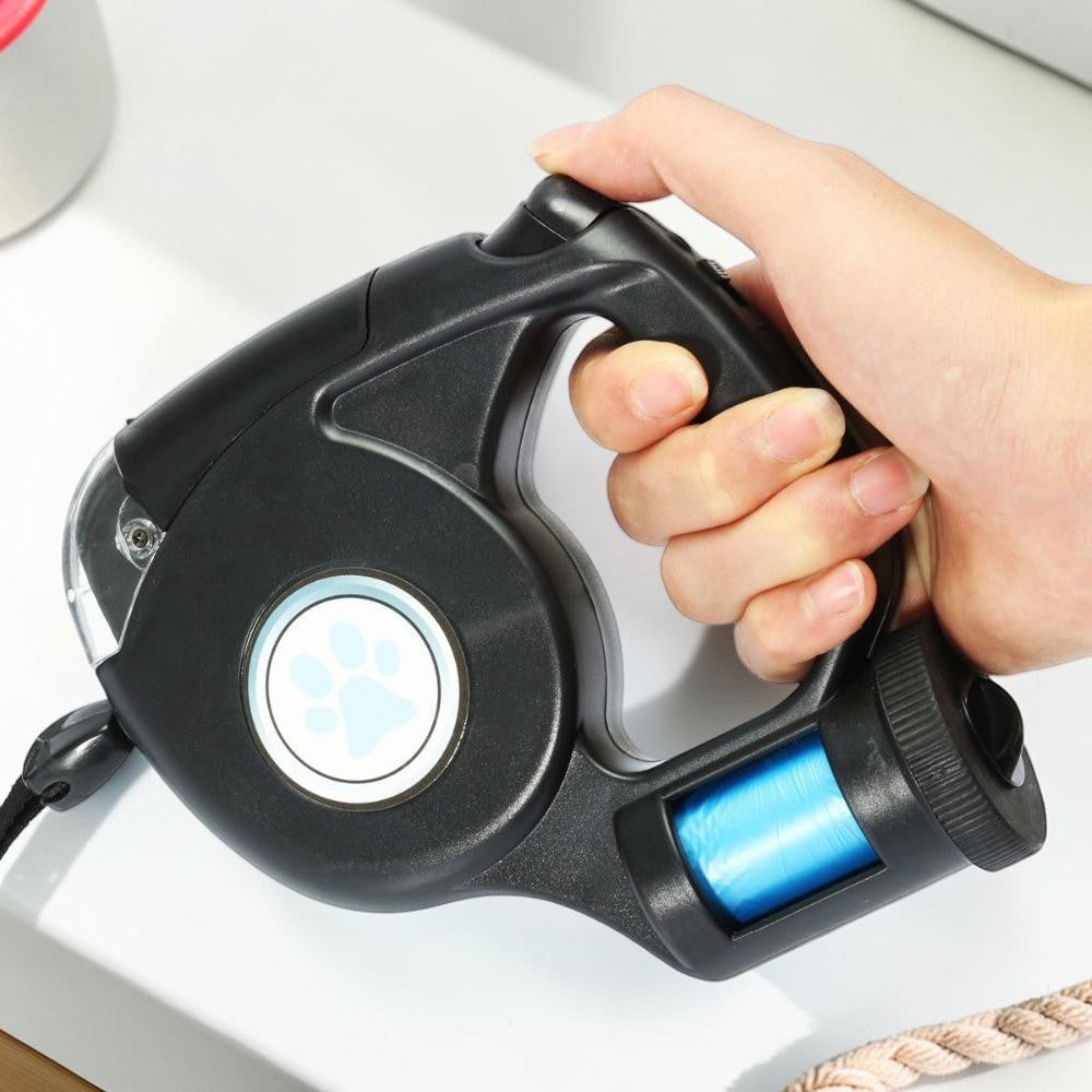 Furvana black LED retractable dog leash with ergonomic handle, thumb lock control, and integrated waste bag dispenser.