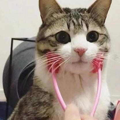 Furvana pet face roller massager with red rollers being used to gently massage a tabby cat's cheeks