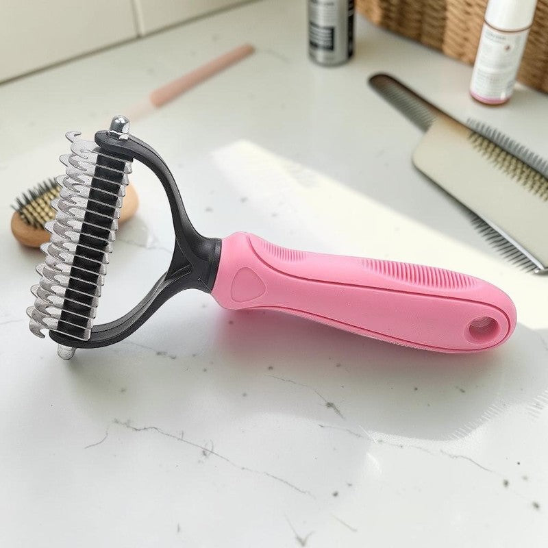Furvana pet fur knot remover comb with dual-sided stainless steel teeth and an ergonomic pink non-slip handle.