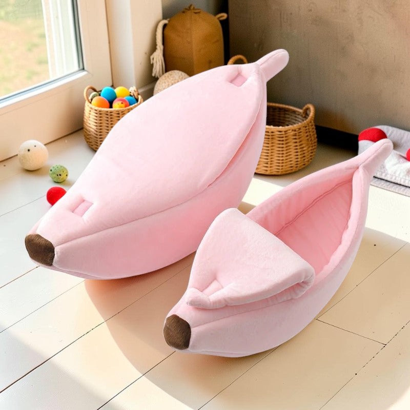Furvana pink banana-shaped pet bed with a peelable top and soft plush fabric for cats and small dogs