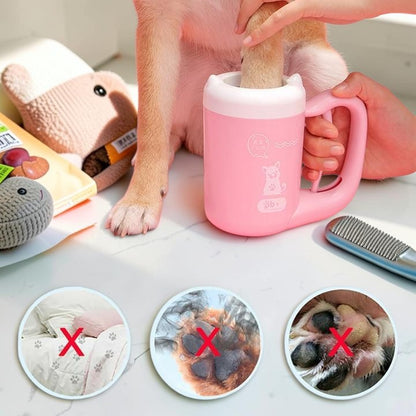Furvana portable pink dog paw cleaner cup with soft silicone bristles being used to wash a dog's muddy paw