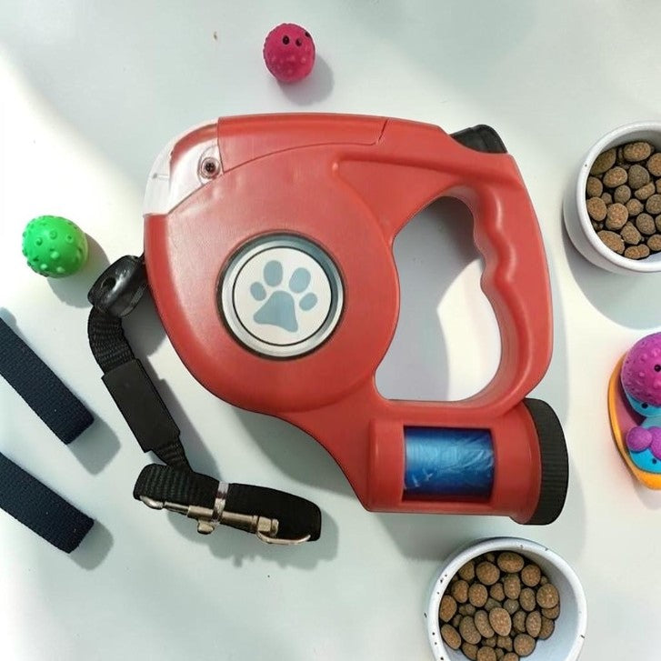 Furvana red retractable dog leash with built-in LED light, ergonomic handle, and integrated waste bag dispenser.
