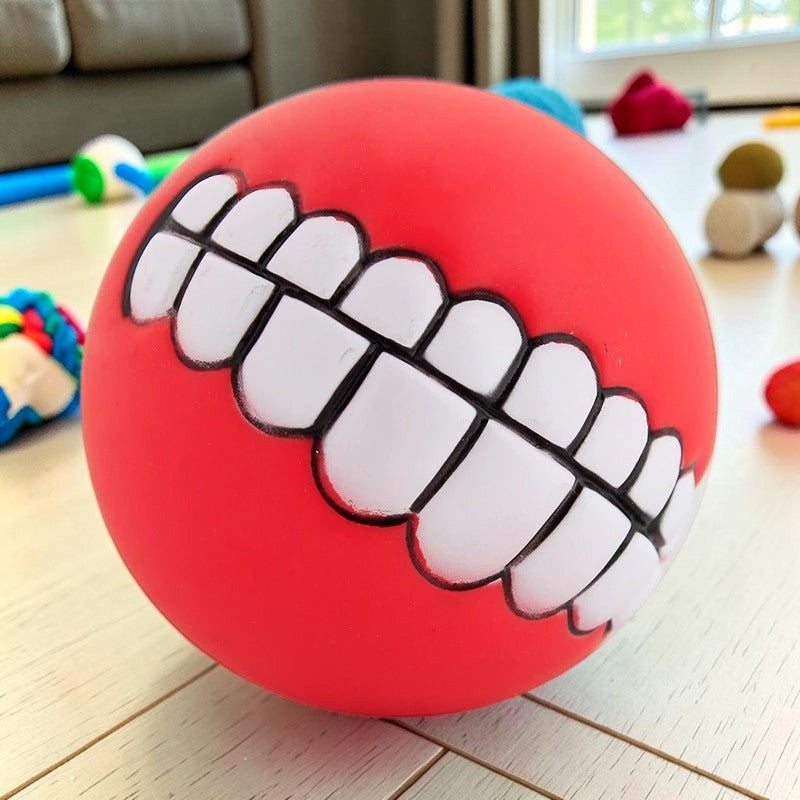 Furvana red squeaky rubber ball toy with a funny human-like toothy grin design for interactive dog play