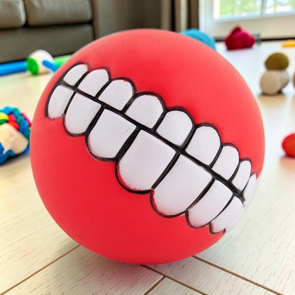 Furvana red squeaky rubber ball toy with a funny human-like toothy grin design for interactive dog play