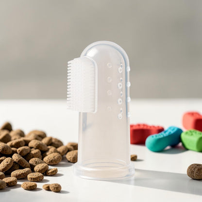 Furvana soft silicone finger toothbrush for dogs and cats to clean teeth and gums, shown with pet food kibble.