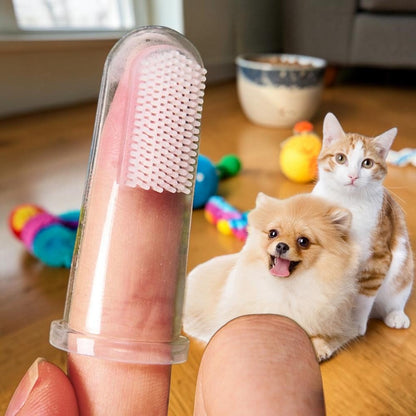 Furvana soft silicone finger toothbrush for dogs and cats held on a finger with a small dog and cat in the background