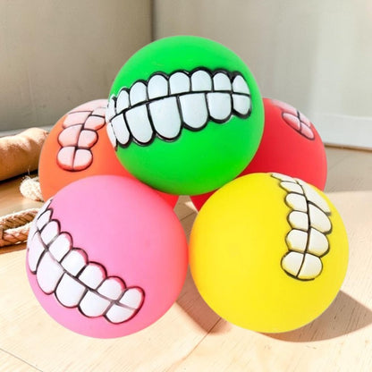 Furvana squeaky rubber pet balls with funny human-like teeth designs in bright green, yellow, pink, and red colors.
