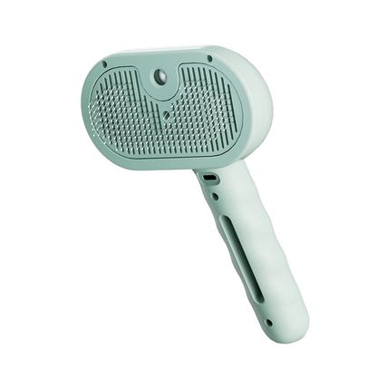 Furvana 3-in-1 steam pet grooming brush in sage green with soft bristles and a comfortable ergonomic handle
