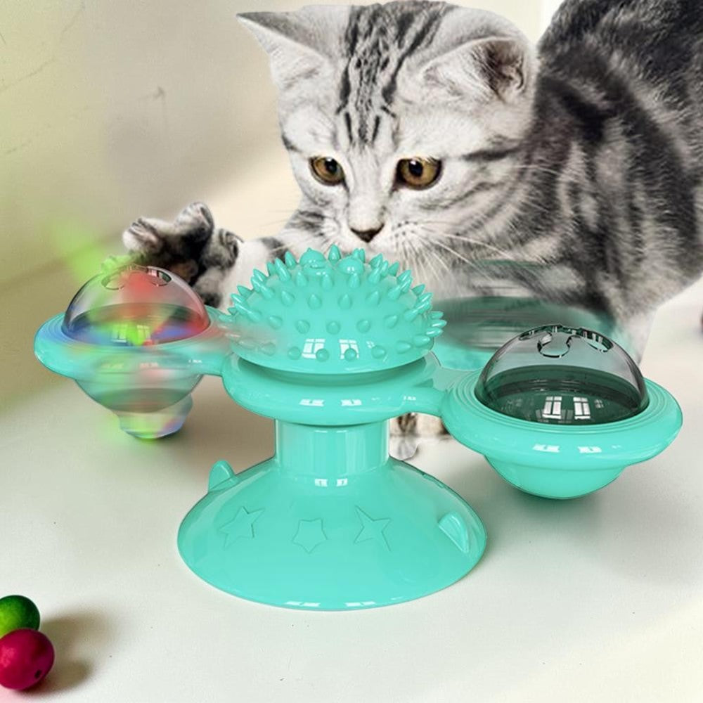 Furvana windmill cat toy in teal with a suction base and spinning interactive compartments being played with by a cat