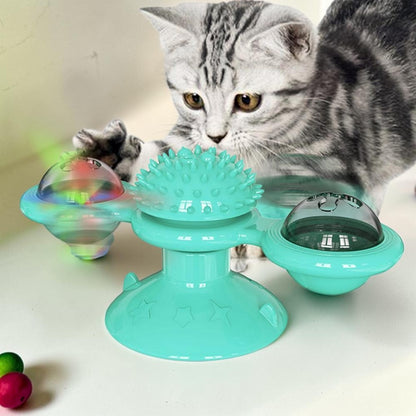 Furvana windmill cat toy in teal with a suction base and spinning interactive compartments being played with by a cat