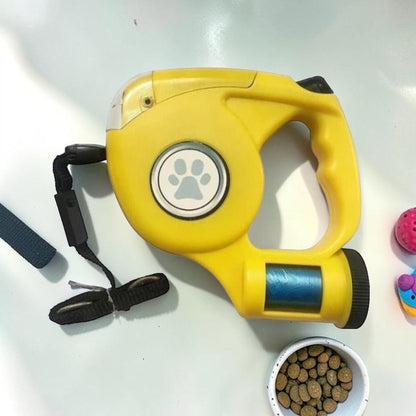 Furvana yellow LED retractable dog leash with ergonomic handle, thumb lock control, and paw print detail on side.