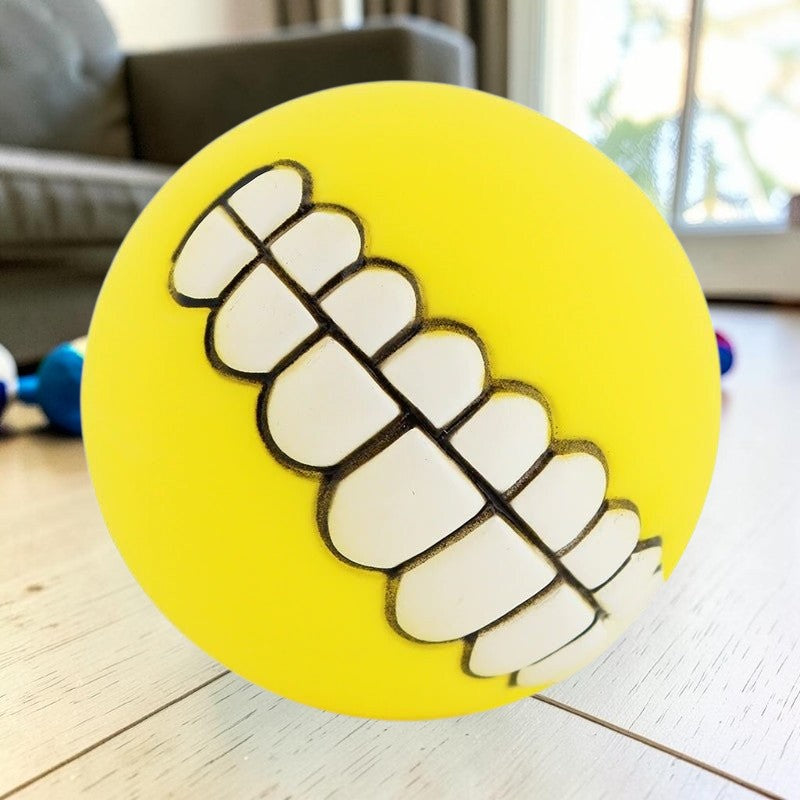 Furvana yellow squeaky rubber ball dog toy with a funny human-like teeth design for interactive fetch play